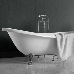 A freestanding white bathtub with ornate silver claw legs and a matching chrome faucet, shown in a bathroom setting with a gray textured towel draped over the side.
