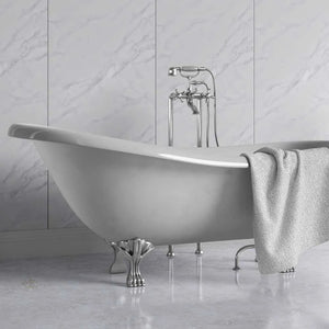 A freestanding oval bathtub with claw feet and a polished chrome faucet set, shown in a bathroom with light marble wall and floor tiles. A textured light gray towel is draped over the side of the tub.