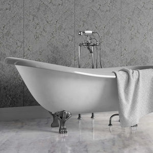 A freestanding white clawfoot bathtub with polished silver metal legs and a matching chrome faucet set, shown in a bathroom setting with gray stone wall panels and a marble floor. A light gray towel is draped over the side.