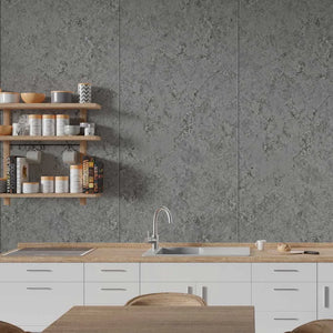Gray stone-look wall tiles installed in a modern kitchen setting with white cabinets, a wooden countertop, and floating wooden shelves.