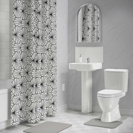 Bathroom with geometric-patterned shower curtain and mirror.