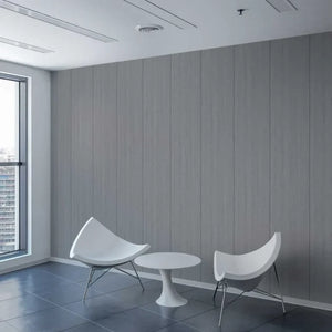 A modern interior scene with two white curved chairs and a small round white table set against a gray wood-paneled wall, with a large window on the left showing a city view.