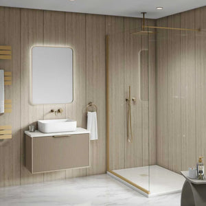 Modern bathroom vanity and walk-in shower enclosure in a light wood-paneled bathroom. The vanity features a white rectangular vessel sink, a ribbed beige cabinet, a large rounded rectangular backlit mirror, and brass fixtures.