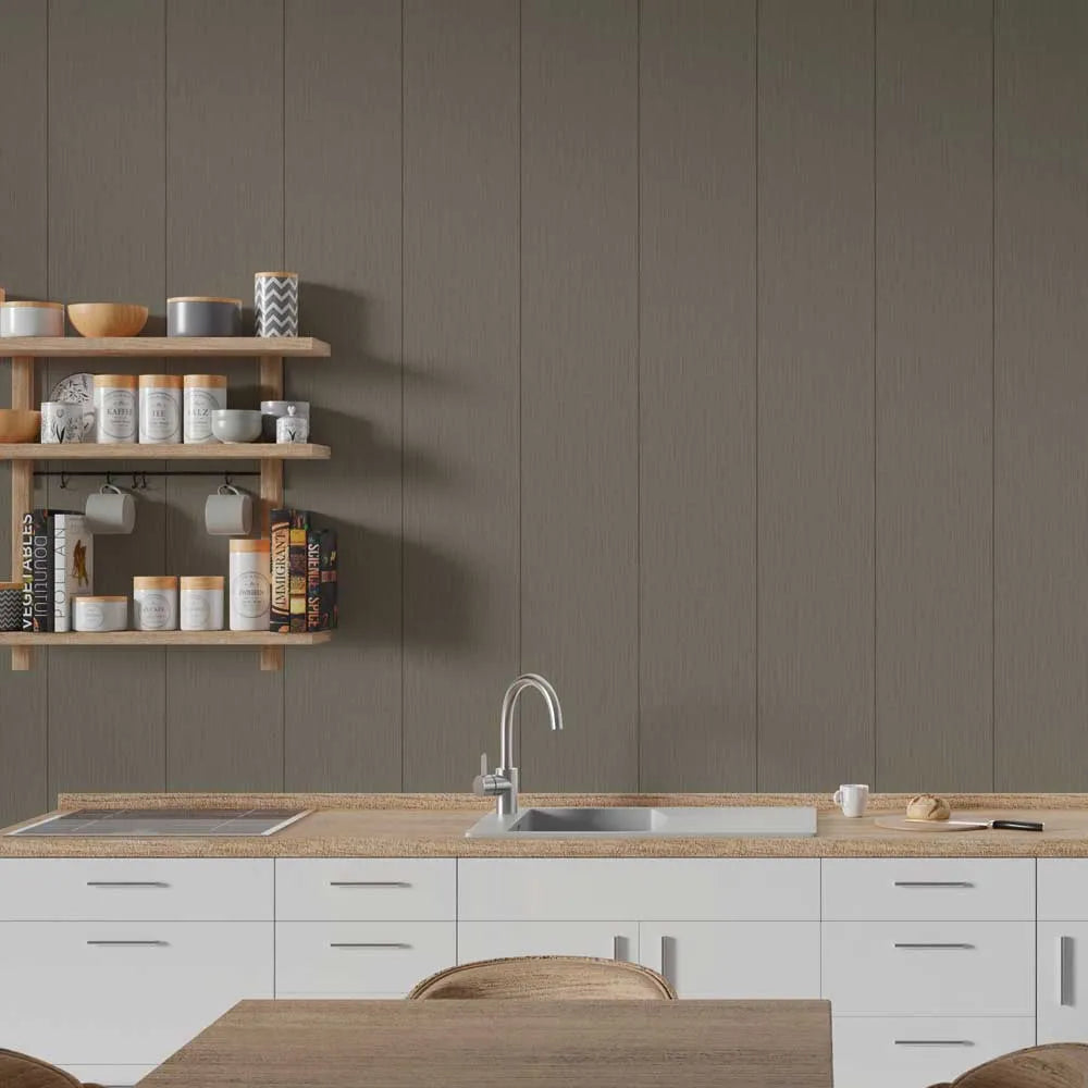 A modern kitchen interior with white cabinets, a light wood countertop, a stainless steel sink and faucet, open wooden wall shelves with jars and bowls, and a large taupe-brown paneled wall behind.