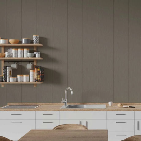 A modern kitchen interior with white cabinets, a light wood countertop, a stainless steel sink and faucet, open wooden wall shelves with jars and bowls, and a large taupe-brown paneled wall behind.