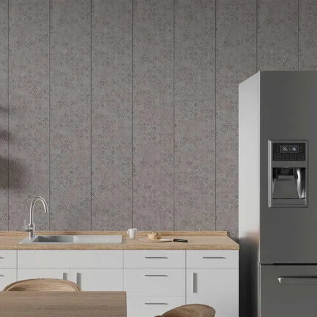 Gray floral patterned wall paneling installed in a modern kitchen setting with white cabinets, a stainless steel sink, and a stainless steel refrigerator.