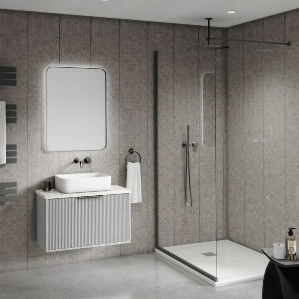 Modern bathroom interior with a floating white vanity, rectangular white sink, wall-mounted mirror, glass shower enclosure, and gray stone-look tiled walls and floor.