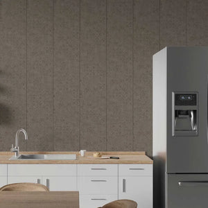 A modern kitchen scene featuring a large stainless steel refrigerator on the right, white lower cabinets with a light wood countertop and sink on the left, and a textured gray damask-patterned wall behind.