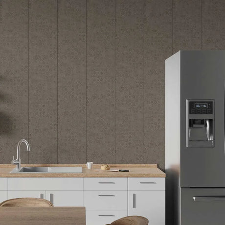 A modern kitchen scene featuring a large stainless steel refrigerator on the right, white lower cabinets with a light wood countertop and sink on the left, and a textured gray damask-patterned wall behind.