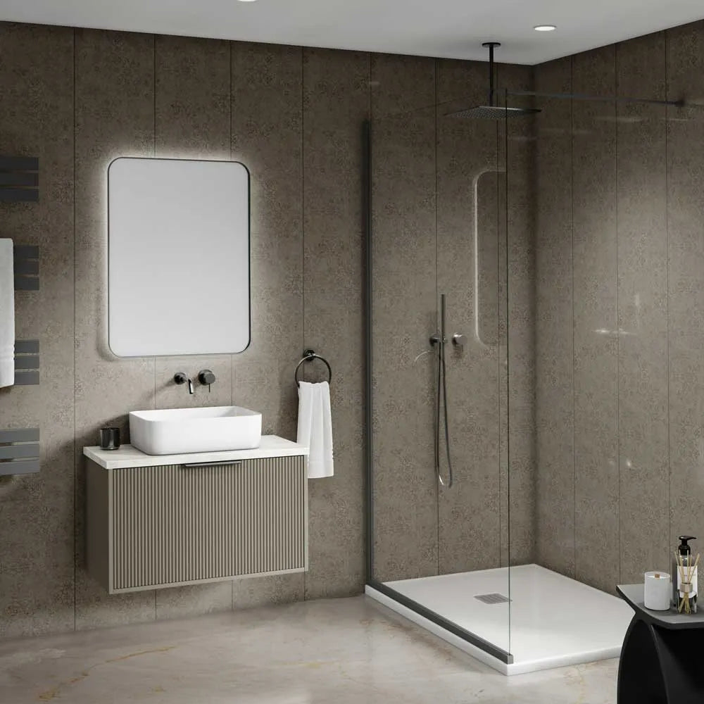 Modern bathroom interior featuring a floating vanity with a white vessel sink, a large rectangular mirror, a walk-in shower with clear glass doors, and textured taupe stone walls and floor.