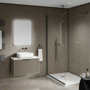 Modern bathroom interior featuring a floating vanity with a white vessel sink, a large rectangular mirror, a walk-in shower with clear glass doors, and textured taupe stone walls and floor.