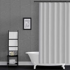 Bathroom with a white bathtub, shower curtain, and wall art on grey pacific mineral wall panels.