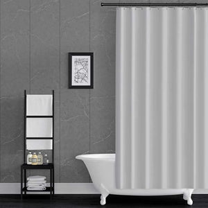 Bathroom with a white bathtub, shower curtain, and wall art on grey pacific mineral wall panels.