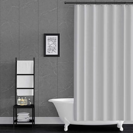 Bathroom with a white bathtub, shower curtain, and wall art on grey pacific mineral wall panels.