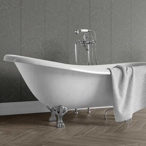 A white freestanding clawfoot bathtub with a chrome faucet and matching gray towel, set against a dark gray marble-look tiled wall and wood herringbone floor.
