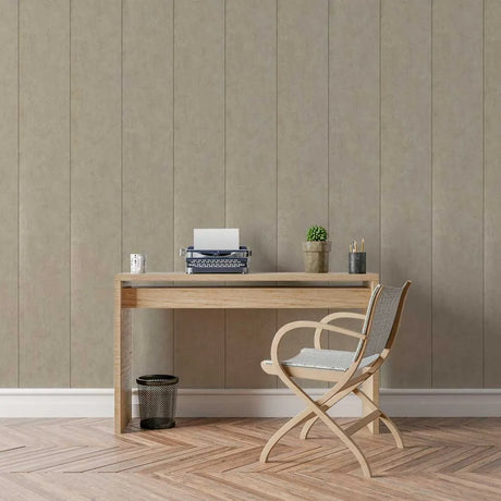 A minimalist home office setup featuring a light oak wood desk and a matching folding chair with a woven seat, set against a beige paneled wall and herringbone wood floor.