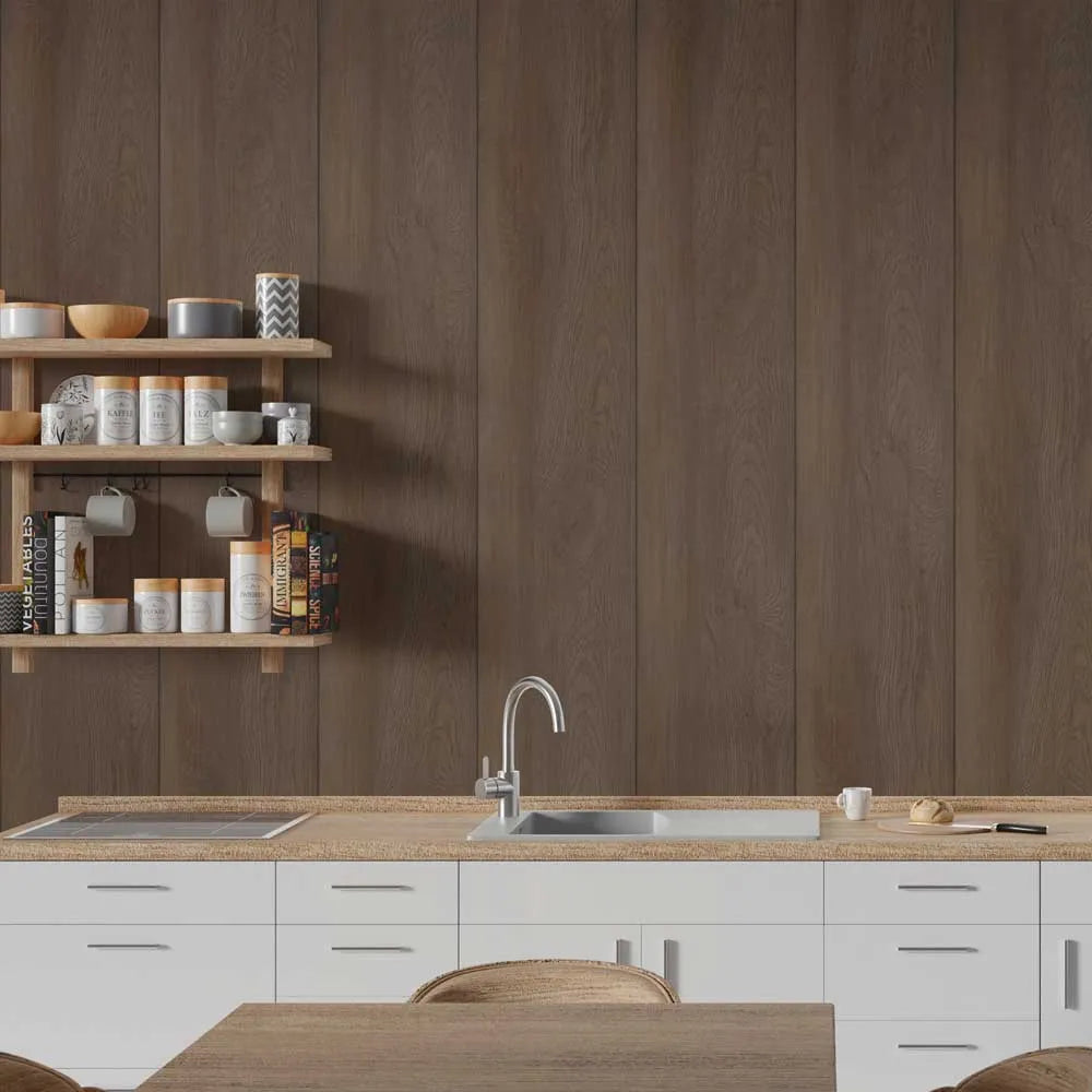 A modern kitchen interior with a dark brown wood-paneled wall, white lower cabinets, a light wood countertop, a built-in sink, and open wooden shelves holding jars and dishes.