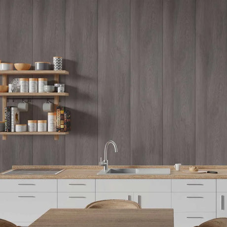 A modern kitchen interior with white lower cabinets, a light wood countertop, a stainless steel sink and faucet, open wooden shelves with jars and bowls, and a dark gray wood-look wall panel background.