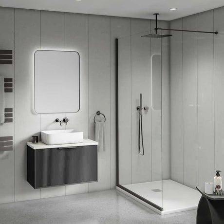 Modern bathroom interior with a floating dark gray vessel sink cabinet, white rectangular basin, illuminated rectangular mirror, glass shower door, and a rain shower overhead.