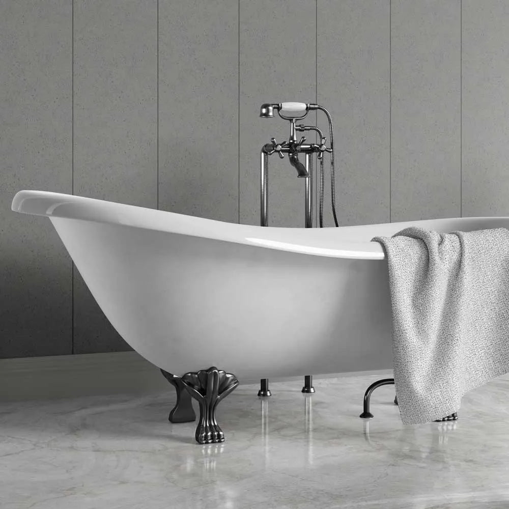 A freestanding white clawfoot bathtub with polished chrome hardware and a draped gray towel, set against a gray paneled wall and marble floor.