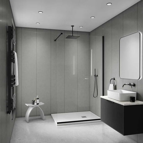 Modern bathroom interior with a walk-in shower, vessel sink, floating vanity, large mirror, and black towel rail against gray paneled walls.