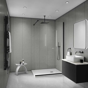 Modern bathroom interior with a walk-in shower, vessel sink, floating vanity, large mirror, and black towel rail against gray paneled walls.