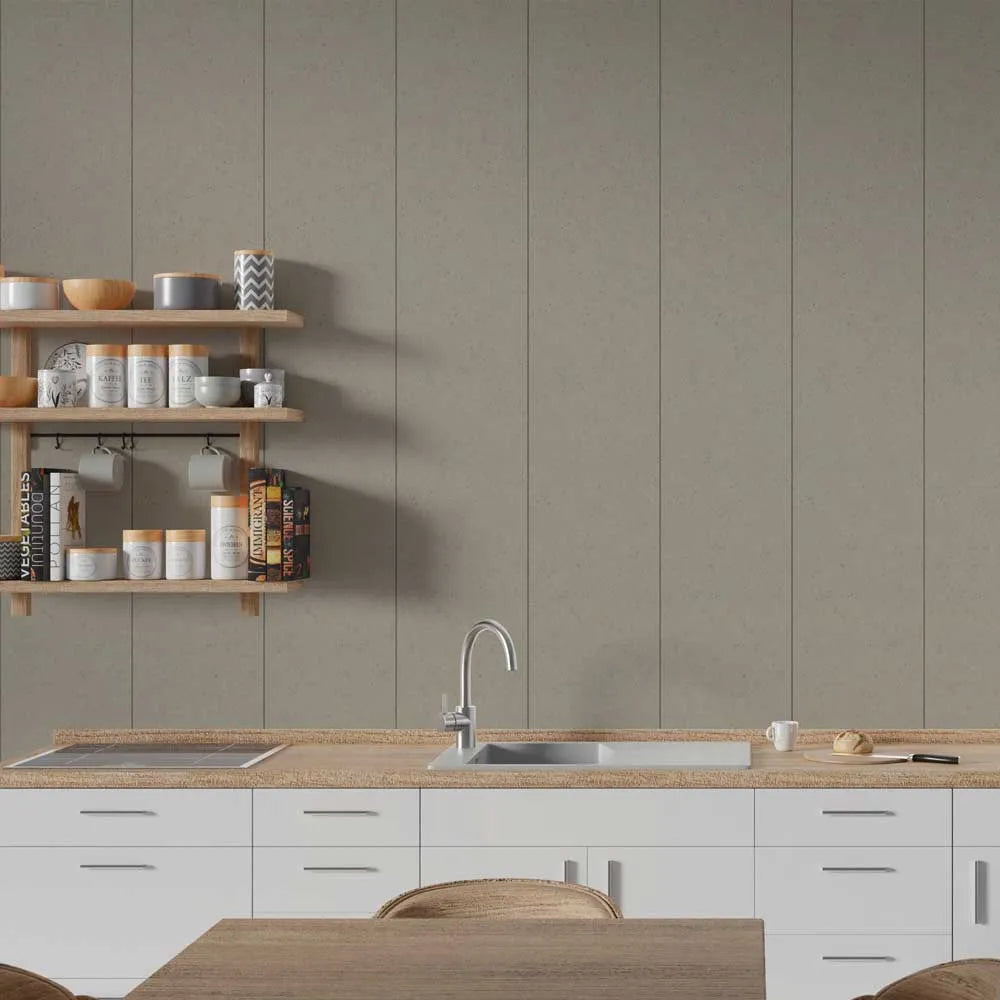 A modern kitchen interior with white cabinets, a light wood countertop, a stainless steel sink and faucet, open wooden shelves with jars and books, and a large taupe-beige paneled wall behind the counter.