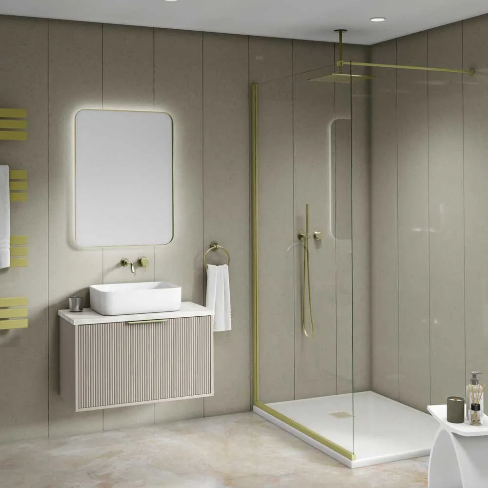 A modern bathroom interior featuring a floating vanity with a white vessel sink, a large rectangular backlit mirror, and a walk-in shower with clear glass panels and brass-toned trim.