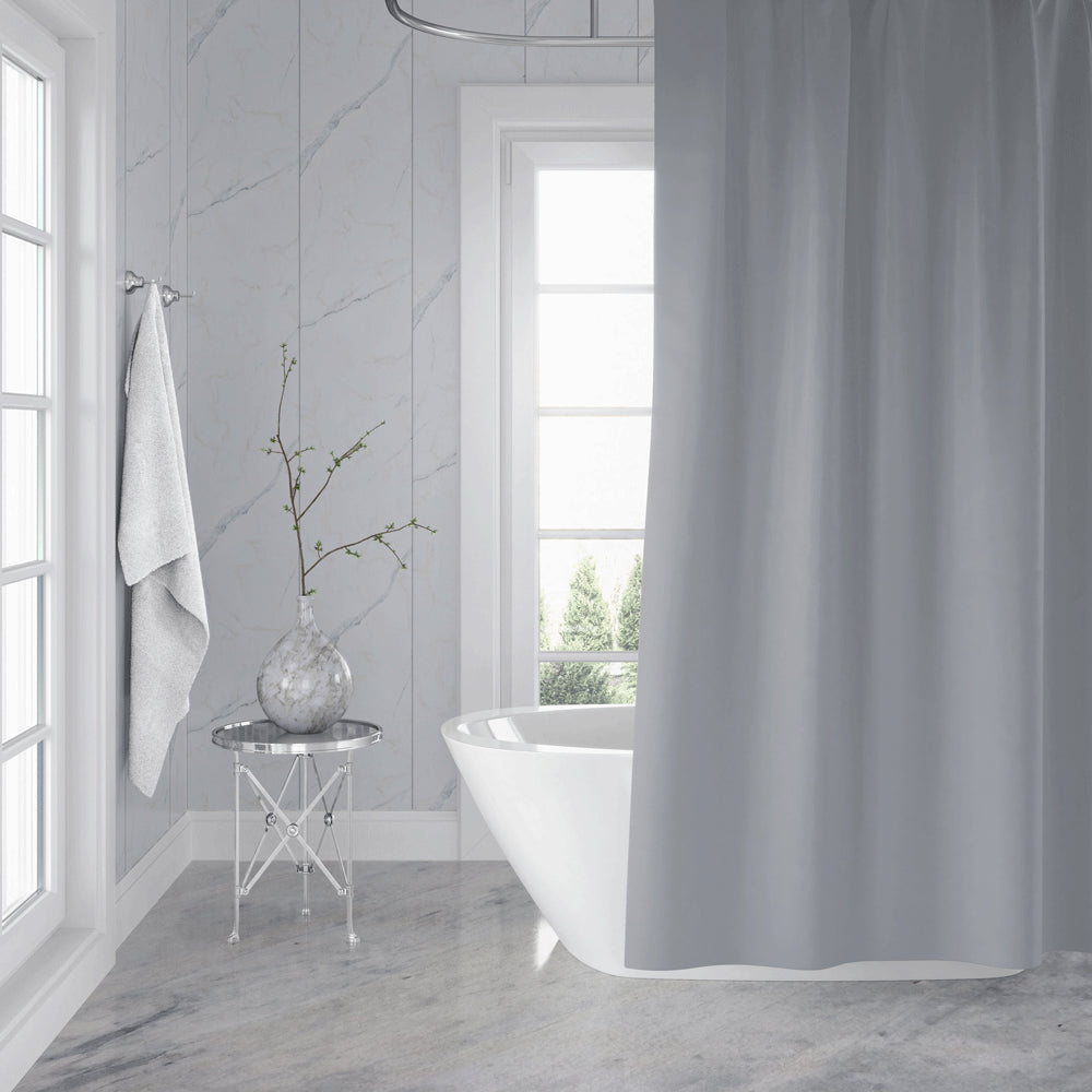 Bathroom with a freestanding bathtub, shower curtain, and decorative elements.