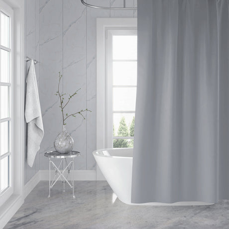 Bathroom with a freestanding bathtub, shower curtain, and decorative elements.