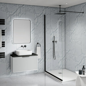 Modern bathroom interior with a floating white vanity, rectangular basin, large mirror, black faucet hardware, a glass shower door, black shower rail, and light gray marble-look wall and floor tiles.