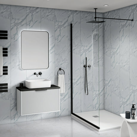 Modern bathroom interior with a floating white vanity, rectangular basin, large mirror, black faucet hardware, a glass shower door, black shower rail, and light gray marble-look wall and floor tiles.