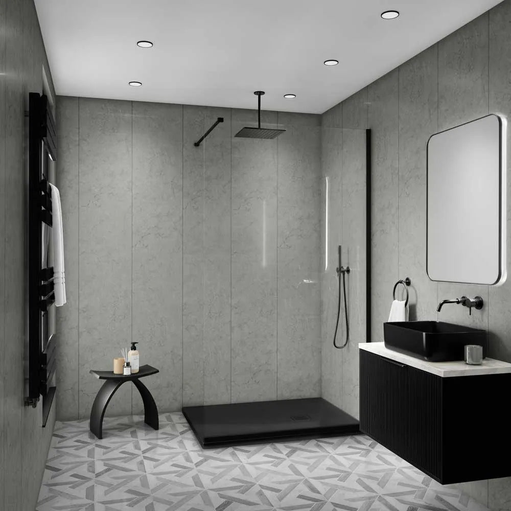 Modern bathroom interior with a walk-in shower area, black vessel sink, white countertop, gray textured walls, patterned floor, and a large rectangular mirror.