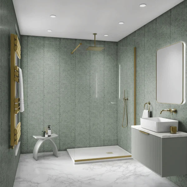 A modern bathroom interior with green textured wall panels, a white marble-look floor, a walk-in shower area with a glass door and gold-toned fixtures, a white vessel sink with a matching vanity, and a gold towel radiator.