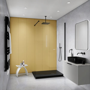 Modern bathroom interior with a large mustard-yellow wall panel behind a walk-in shower area, gray textured walls, a black shower head and floor tray, a white vanity with a black sink, and a rectangular mirror.