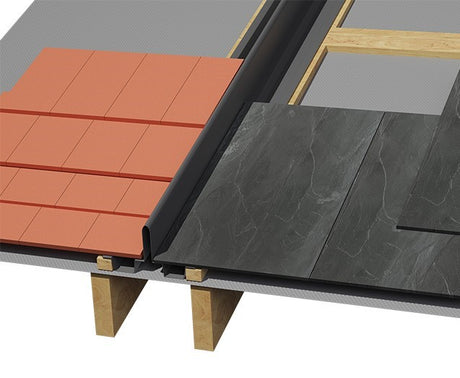 Close-up of a roofing system showing terracotta orange roof tiles on the left and dark charcoal gray stone-look tiles on the right, separated by a black ridge board, mounted on wooden deck joists.