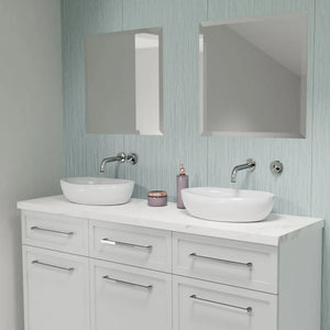 Bathroom vanity with two white sinks, mirrors, and decorative items on a light blue wall.