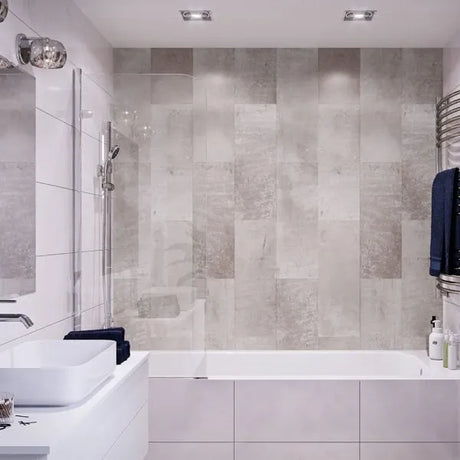 Modern bathroom with tiled walls, a bathtub, and sink.