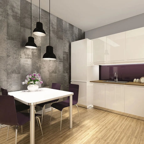 A modern kitchen and dining area with white cabinets, a dark purple backsplash, a gray stone-look accent wall, black pendant lights, a white dining table, and purple chairs.
