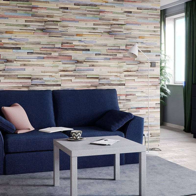 Modern living room with a blue sofa, coffee table, and multicolored wall panels