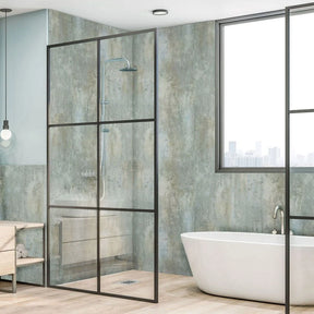 A modern glass shower enclosure with a black metal frame in a contemporary bathroom, shown alongside a freestanding white bathtub and textured walls.