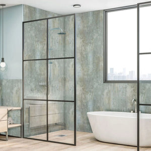 A modern glass shower enclosure with a black metal frame in a contemporary bathroom, shown alongside a freestanding white bathtub and textured walls.