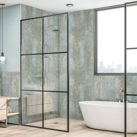 A modern glass shower enclosure with a black metal frame in a contemporary bathroom, shown alongside a freestanding white bathtub and textured walls.