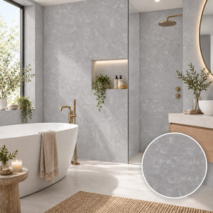 A modern bathroom interior with light gray textured wall tiles, a freestanding white bathtub, gold-toned fixtures, a glass shower enclosure, and a circular inset showing a close-up of the tile surface.