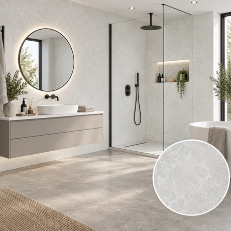 A modern bathroom interior with large light gray stone-look floor tiles, a floating white vanity, a round backlit mirror, and a glass shower enclosure. A circular inset at the bottom right shows a close-up of the tile surface texture.